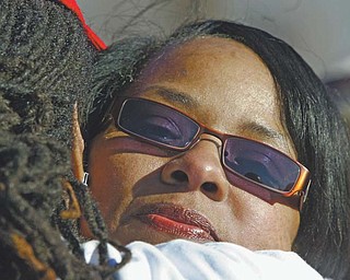 Shirlene Hill, mother of Jamail Johnson, a Youngstown State University senior who was murdered a year ago Monday, is embraced during a march in her son’s memory and a plea to stop area violence.