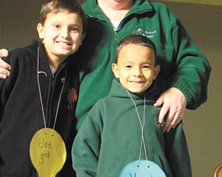 Getting ready for official bee: St. Patrick School in Hubbard, in addition to the annual spelling bee for older kids, has a spelling bee for students in first through third grades to get them ready for the official bee. At left, third-grader Joe Madeline won first place, and at right, second-grader Vincent LeBron was the runner-up. In the middle is Principal Cindy Lacko.