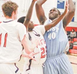 East High’s Deontay Scott (40) tries to drive through the defense of Fitch’s Jessie Driver (25) and Dan
Chepke (11) during the first quarter of Tuesday’s game at Fitch.