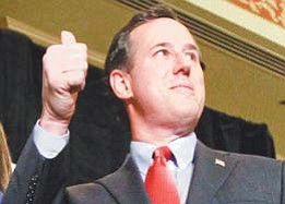Rick Santorum, GOP presidential candidate and former Pennsylvania senator, gives a thumbs-up at a party in St.
Charles, Mo. Santorum won the Missouri primary and the Minnesota caucuses Tuesday.