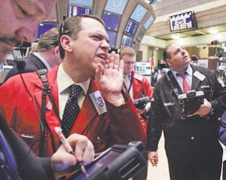 Trader Michael Zicchinolfi , second from left, works on the floor of the New York Stock Exchange on Wednesday.