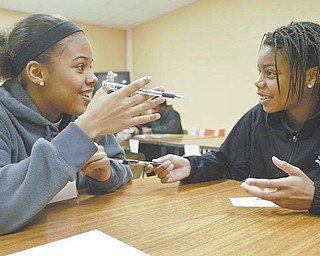 Brae Hudson, left, and Chmicka Kennedy, juniors at Choffi n Career and Technical Center in Youngstown, participate in Junior Achievement of Mahoning Valley’s Success Skills program Wednesday at the school.