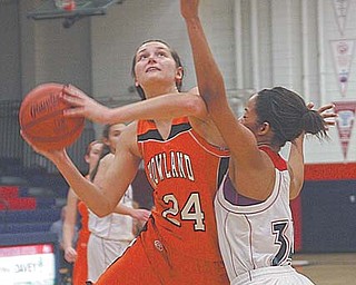 Howland’s Taylor Williams (24), under pressure from Fitch’s Brianna Edwards (34), prepares to shoot during an All-American Conference basketball game Thursday in Austintown. Williams, a 1,000 point scorer and reigning second team all-Ohio honoree who is headed to Princeton University, posted 16 points and grabbed nine rebounds to help lead the Tigers over the Falcons, 54-38.