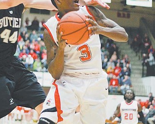 Kendrick Perry (3) of Youngstown State is fouled by Butler’s Andrew Smith (44) as he goes in for a layup during
their Horizon League game Thursday at YSU’s Beeghly Center. Perry posted 23 points, but the Penguins fell to
the Bulldogs, who rallied in the final minutes to win 68-59.