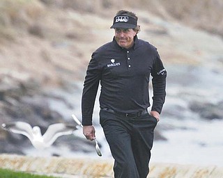 Phil Mickelson smiles as he heads onto the 18th green of the Pebble Beach Golf Links during Sunday’s final round of the 2012 AT&T Pebble Beach National Pro-Am in Pebble Beach, Calif. Mickelson, who started out head-to-head with Tiger Woods, surged up the leaderboard from six strokes back to pass Woods and win the tournament by three strokes.