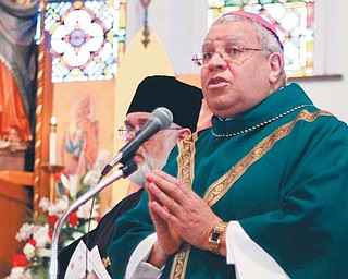 Youngstown Diocese Bishop George V. Murry speaks to parishioners of Our Lady of Hungary Church
during its final Mass on Sunday. Construction began on the church in 1929 and was not fully completed
until 1949. The church served as a communal gathering place for the city’s Hungarian immigrants, who
flocked to Youngstown to work in the city’s steel mills. Declining population hastened its closing and
merger with two other Roman Catholic churches in Youngstown.