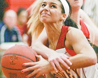 Mooney’s Brie Ozenghar is fouled by Fitch’s Sarah Melfe during the first half of Monday’s game at
Cardinal Mooney High School.