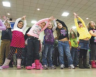 Poland Union Elementary students stretch and dance Wednesday during a Radio Disney dance party. Union is one of 20 schools in Ohio to win the “Anthem Blue Cross and Blue Shield Get Active, Get Fit School Challenge” sponsored by Radio Disney.
