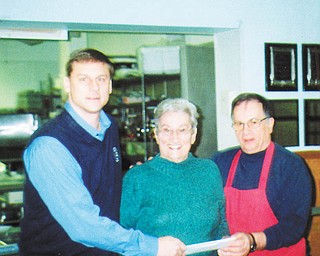 Slovak Ladies benefit: Bernie Demechko, center, presents a $5,000 check to Brian Antal, left, president of the Mahoning County Saint Vincent de Paul Society, and Ralph Barone, St. Vincent de Paul dining hall manager. Demechko is the district president of the First Catholic Slovak Ladies Association of Beachwood, Ohio, a nonprofit financial benefit society. The dining hall serves more than 90,000 meals annually and its food pantry distributes food to 8,500 people. It also distributes 100 sack lunches daily to after-school “latchkey” students from area schools. The FCSLA distributed $1,000,000 in donations at its October convention in Baltimore.