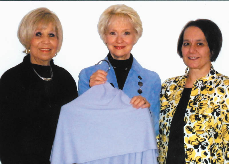 Pictured from left to right are Audrey Gillian, Diane Ferro and Carol Bertolini. Youngstown Symphony Guild members who are helping the guild prepare for its Trunk Show Extravaganza, scheduled from 10 a.m. to 3:30 p.m. March 3 at the DeYor Center for Performing Arts, Youngstown. Ferro is holding a cashmere shawl, which patrons will have a chance to win at the fundraiser.