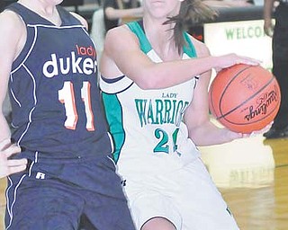 West Branch’s Rebekah Zets (24) looks to put up a shot over Marlington defender Katie Reed (11). The No. 2 seeded Warriors open postseason play tonight against the Hubbard Eagles during the Division II tournament at
Austintown Fitch High School.