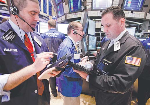 Traders work on the floor of the New York Stock Exchange. The Dow Jones industrial average has soared
62 percent since President Barack Obama took office.