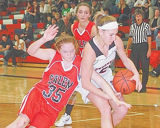 Ashley Hefferon, right, of Struthers tries to keep the ball as Raegan Meals (35) of Salem goes for a steal during Monday’s Division II sectional tournament game. The Wildcats advanced with a 66-40 victory.