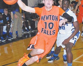 Newton Falls senior Cody Dillon (10) loses control of the ball while dribbling around Youngstown Christian defender JayQuan Yanno during Tuesday’s game at YCS.