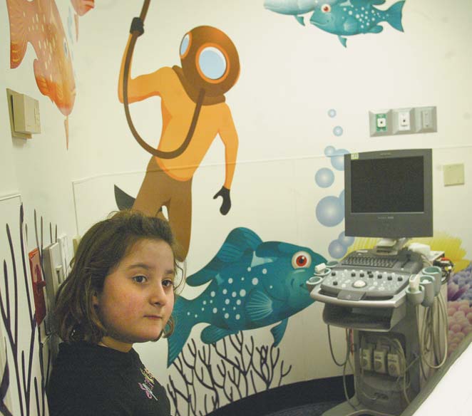 Tiana Aurilio, a patient at Akron Children’s Hospital Mahoning Valley in Boardman, checks a room in the radiology department decorated with new colorful graphics designed to put young patients more at ease.