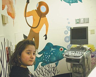 Tiana Aurilio, a patient at Akron Children’s Hospital Mahoning Valley in Boardman, checks a room in the radiology department decorated with new colorful graphics designed to put young patients more at ease.