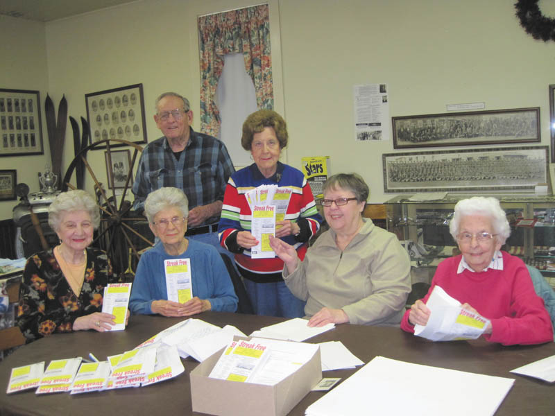 A group of Niles Historical Society members are stuffing envelopes for the sale of “streak free” microfiber cloths, a new venture designed to fund the New Research/Lecture Center Building at the Ward-Thomas Museum. Seated from left are Julie Miscevich, Betty Whitney, Pat Pfeifer and Ruth Van Huffel. Standing are George John and Nancy Malone.