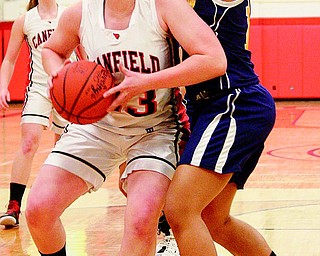 Sarah Vrabel (23) of Canfield tries to get drive around Streetsboro defender Shania William (10) during a Division II first-round sectional basketball game Wednesday at Austintown Fitch High School. The Cardinals slipped past the Rockets, 36-27.