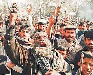Afghans shout anti-U.S. slogans during a demonstration in Mehterlam, Laghman province east of Kabul on Thursday. Afghan police fired shots into the air to disperse hundreds of protesters who tried to break into an American military base in the country’s east to vent their anger over this week’s Quran-burning incident.