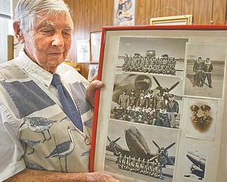 David Hall, Girard city engineer, holds a frame depicting three of the nine planes he flew during and just after World War II when he was in the U.S. Army Air Corps. Hall has been with the city for 12 years.