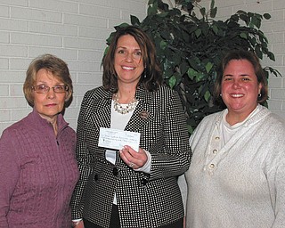 JWL event benefits group: The Junior Women’s League of Canfield hosted a wine and beer taste Jan. 29 at Vintage Estate, South Avenue, Boardman. Proceeds benefited the Down Syndrome Association of Mahoning Valley. A checkfor $840 was presented to Michele Jones, center, president of the Down Syndrome Association. Standing with Jones are Judy Buck, left, Ways & Means Committee chairwoman of the JWL group, and Marnie Murphy, its president.
