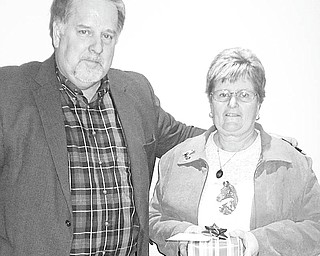 The Columbiana County Fair Board honored Julie Herron on Jan. 25 for her 12 years of service to the county 4-H programs and Junior Fair. Don Humphrey Jr., above, president of the fair board, presented Herron with a token of appreciation. She retired Jan. 31, and a farewell open house took place in her honor at the extension office.