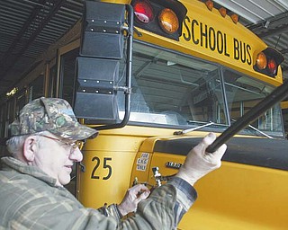 Compressed natural gas vehicles are sparingly used despite an overabundance of the natural resource. Some businesses, however, have begun converting their fleets to CNG. At Lakeview schools in Cortland, the district since the late 1990s has used seven CNG-retrofitted buses. Here, Robert Czako, mechanic, fills a school bus with CNG.