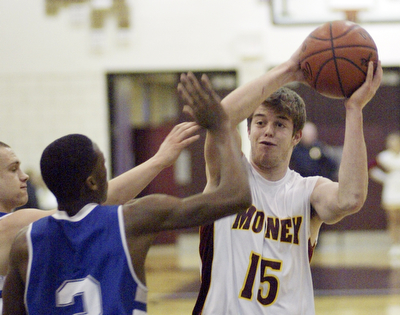 William d Lewis the vindicator  Mooney's PJ Quinnshoots over Darnell Tateof Hubbard during Monday action at Boardman.
