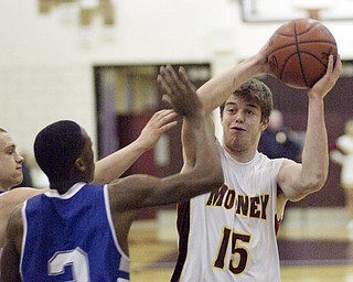 William d Lewis the vindicator Mooney's PJ Quinnshoots over Darnell Tateof Hubbard during Monday action at Boardman.