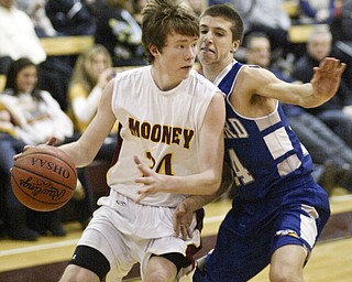William d Lewis the vindicator Mooney's George Brandenstein dribbles around Nick Shelton of Hubbard during Monday action at Boardman.