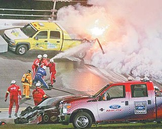 Emergency workers put out a fire on a jet dryer after it was struck by Juan Pablo Montoya’s car in Lap 160 of the Daytona 500 on Monday at Daytona International Speedway. Trumbull County native Dave Blaney was leading the race when it was halted with 40 laps to go. It had not restarted by press time.