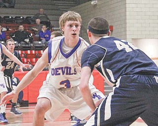 Lowellville’s Dean Donatelli (42) is closely guarded by Western Reserve’s Tim Cooper (3) during the
second half of the Division IV sectional semifinal Monday at Struthers Fieldhouse. The Rockets edged
the Blue Devils, 29-26.