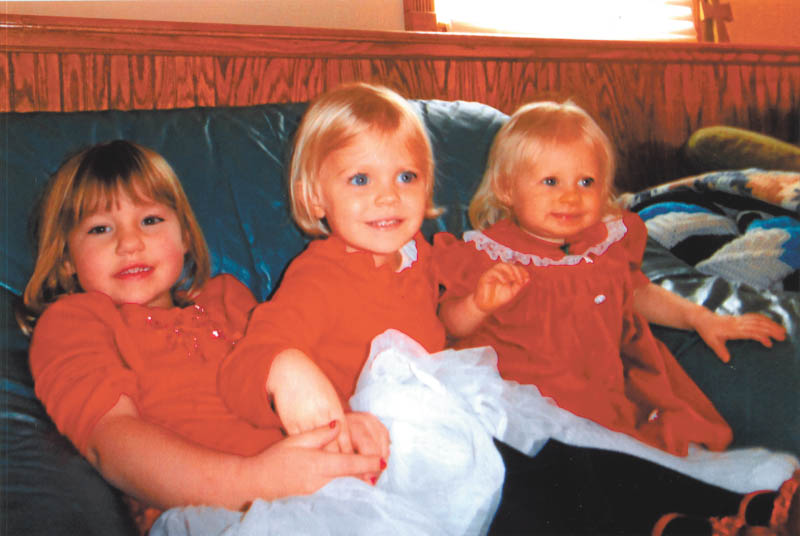 Madison Wright, Hannah Cantaneo and Lydia May are all decked out in their red dresses. Photo taken by Marilyn Cavanaugh of Columbiana.
