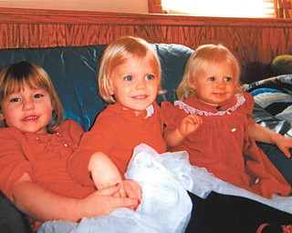 Madison Wright, Hannah Cantaneo and Lydia May are all decked out in their red dresses. Photo taken by Marilyn Cavanaugh of Columbiana.