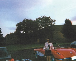 Deborah Carissimi of Boardman stands near her Corvette convertible.