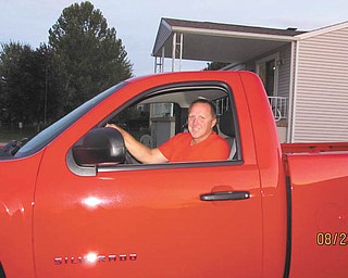 Jennifer Campman sent this picture of her husband, Dave Campman, and his new truck that he purchased in August 2011. She says it's "victory" red, along with the red shirt he is wearing.