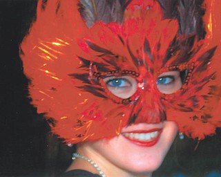 Leanna Hartsough of Canfield went to New Orleans and donned a bright feather mask. Photo from Lana VanAuker of Canfield.