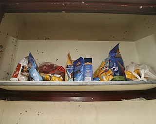 JESSICA M. KANALAS | THE VINDICATOR..A shelf full of dog treats sits in a closet packed with bags of dog food and other pet necessities.