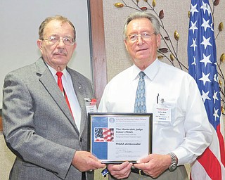 The Hon. Robert P. Milich, right, judge of Youngstown Municipal Court, is presented with the MOAA Ambassador Award from Col. Walter Duzzny, U.S.A., Ret., president of the Mahoning and Shanango Valleys Chapter of the Military Officers Association of America. Judge Milich is a retired Lt. Col. of the U.S. Air Force. The MOAA Ambassador Award is the first presented by the local chapter.