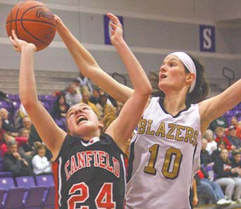 Rachel Tinkey (24) of Canfield puts up a shot against Stephanie Poland of Hathaway Brown during Tuesday’s game in Barberton.