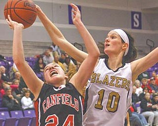 Rachel Tinkey (24) of Canfield puts up a shot against Stephanie Poland of Hathaway Brown during Tuesday’s game in Barberton.