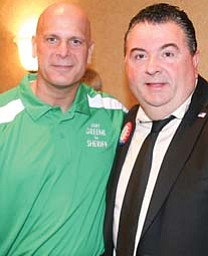 Jerry Greene, Mahoning County sheriff-elect, left, and Mahoning County Commissioner Anthony Traficanti mark
their victories Tuesday during a gathering at the B&O Station in Youngstown.