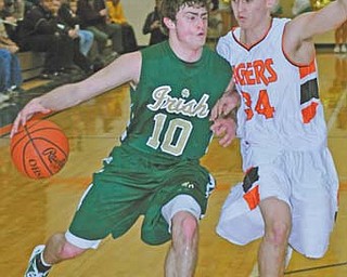 Ursuline’s Ryan Strollo (10) dribbles against Newton Falls defender Mike Staton during Tuesday’s tournament game at Howland.