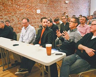 Panelist Tony DeAscentis, second from right, CEO of Via680, gives feedback to Chris Ostoich, an entrepreneur from Cincinnati, about Ostoich’s pitch at the Youngstown Business Incubator for a nonpassive music program. The Youngstown Business Incubator hosted the Ohio Startup Bus, a bus of 30 entrepreneurs traveling to the South By Southwest Festival in Austin, Texas. The entrepreneurs pitched their ideas for a start-up business to a panel of YBI judges.