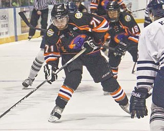 Pat Conte (71) of the Youngstown Phantoms prepares to shoot past Indiana Ice defenseman Matthew
Krug (6) during the first period of Wednesday’s USHL game at the Covelli Centre. The Phantoms defeated
the Ice in a fight-fraught contest, 6-3.