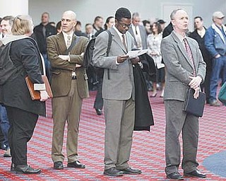 Job seekers stand in line during the Career Expo job fair Wednesday in Portland, Ore. The Labor Department said Thursday that weekly applications increased by 8,000 to a seasonally adjusted 362,000, the highest level since January.