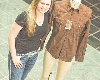 Shannon Gallagher of Garrettsville proudly shows off the men’s Western-style shirt she designed. Wrangler will produce and sell her design, beginning it its Christmas 2012 catalog. Gallagher is in her fifth year as a fashion merchandising major at Kent State University. For more about KSU’s Fashion School, visit www.kent.edu/artscollege/fashion.