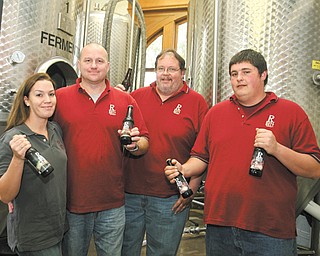 Jillian and Ken Blair, left, Brian S. Koniowsky, brewmaster, and Brian J. Koniowsky make up the small team at Rust Belt Brewing in Youngstown.