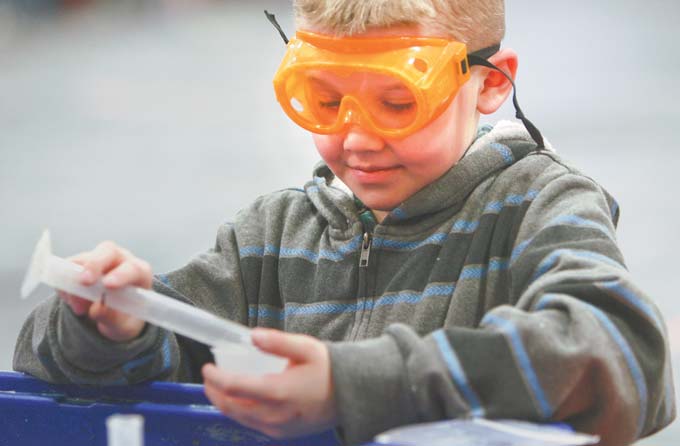 Jacob Scolville, a fourth-grader at E.J. Blott Elementary in Liberty, mixes his own batch of slime in the gymnasium. On Wednesday, the Center on Science Industry’s traveling exhibit called “It’s Simple Chemistry” brought hands-on science activities to the students.