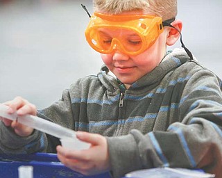 Jacob Scolville, a fourth-grader at E.J. Blott Elementary in Liberty, mixes his own batch of slime in the gymnasium. On Wednesday, the Center on Science Industry’s traveling exhibit called “It’s Simple Chemistry” brought hands-on science activities to the students.